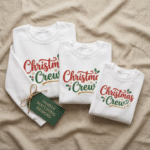 Three folded white Christmas sweatshirts featuring matching “Christmas Crew” designs in festive red and green typography, displayed with a gift tag labeled “Family Matching Designs.” Cozy holiday clothing set representing Christmas sweatshirt designs.