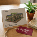 A card featuring an eco-design community garden pavilion with solar panels and green roofing, styled on a wooden table with a plant, woven coaster, and a red tag labeled “Sustainable Design.”